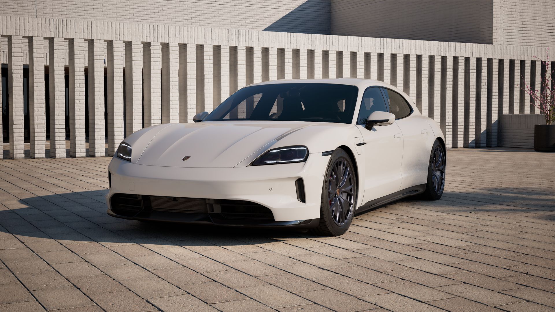 Außenansicht von Taycan GTS Sport Turismo mit der Vorderseite und der linken Seite des Fahrzeugs