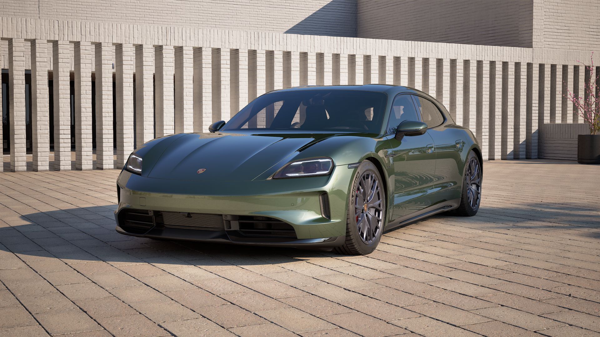 Außenansicht von Taycan GTS Sport Turismo mit der Vorderseite und der linken Seite des Fahrzeugs