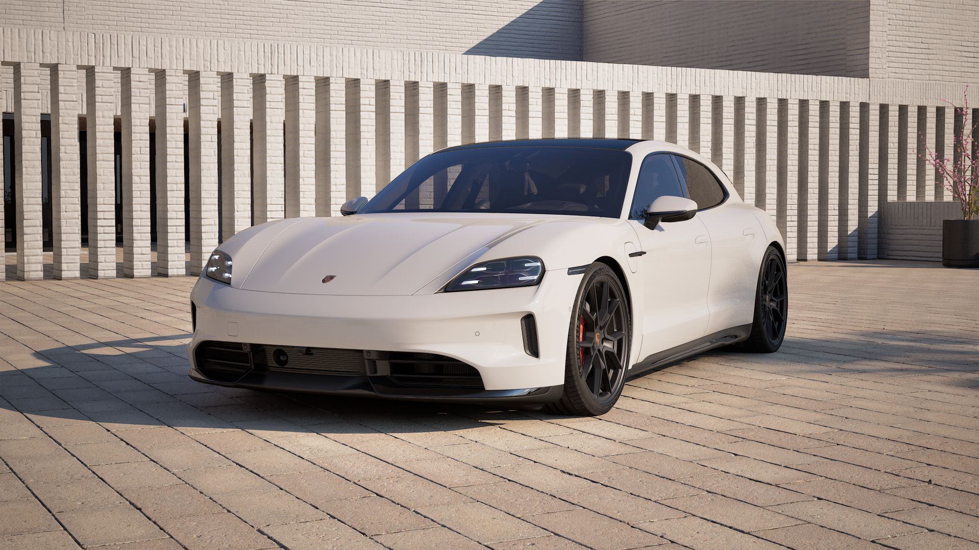 Außenansicht von Taycan GTS Sport Turismo mit der Vorderseite und der linken Seite des Fahrzeugs