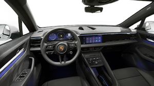 Interior view showing the steering wheel and dashboard of Macan 4