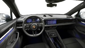 Interior view showing the steering wheel and dashboard of Macan 4