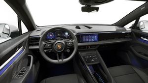 Interior view showing the steering wheel and dashboard of Macan 4