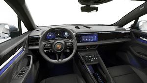 Interior view showing the steering wheel and dashboard of Macan Electric