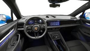 Interior view showing the steering wheel and dashboard of Macan 4 Electric