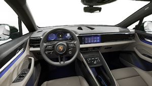 Interior view showing the steering wheel and dashboard of Macan 4 Electric