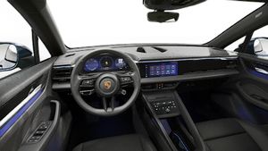 Interior view showing the steering wheel and dashboard of Macan 4 Electric