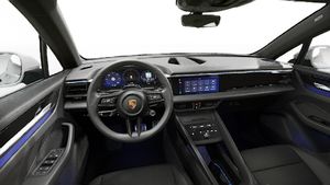 Interior view showing the steering wheel and dashboard of Macan 4S Electric