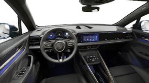 Interior view showing the steering wheel and dashboard of Macan Turbo Electric