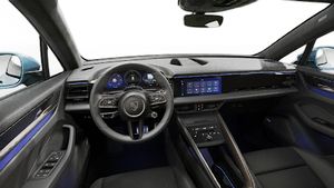 Interior view showing the steering wheel and dashboard of Macan Turbo Electric
