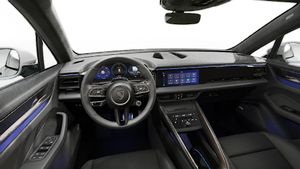 Interior view showing the steering wheel and dashboard of Macan Turbo Electric