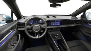 Interior view showing the steering wheel and dashboard of Macan Turbo Electric