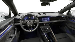 Interior view showing the steering wheel and dashboard of Macan Turbo Electric
