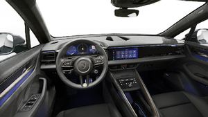 Interior view showing the steering wheel and dashboard of Macan Turbo Electric