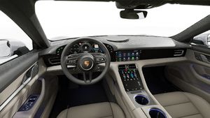 Interior view showing the steering wheel and dashboard of Taycan