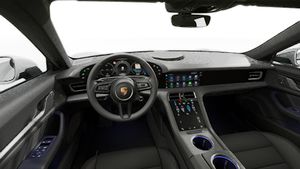 Interior view showing the steering wheel and dashboard of Taycan 4
