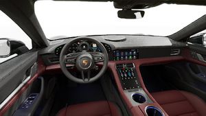 Interior view showing the steering wheel and dashboard of Taycan 4