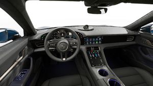 Interior view showing the steering wheel and dashboard of Taycan Turbo