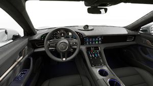 Interior view showing the steering wheel and dashboard of Taycan Turbo