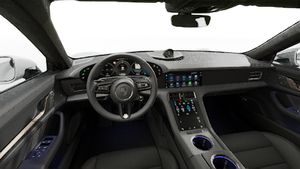 Interior view showing the steering wheel and dashboard of Taycan Turbo