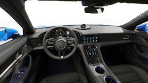 Interior view showing the steering wheel and dashboard of Taycan Turbo S