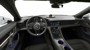 Interior view showing the steering wheel and dashboard of Taycan Turbo S
