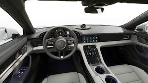 Interior view showing the steering wheel and dashboard of Taycan Turbo S