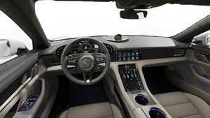 Interior view showing the steering wheel and dashboard of Taycan Turbo S